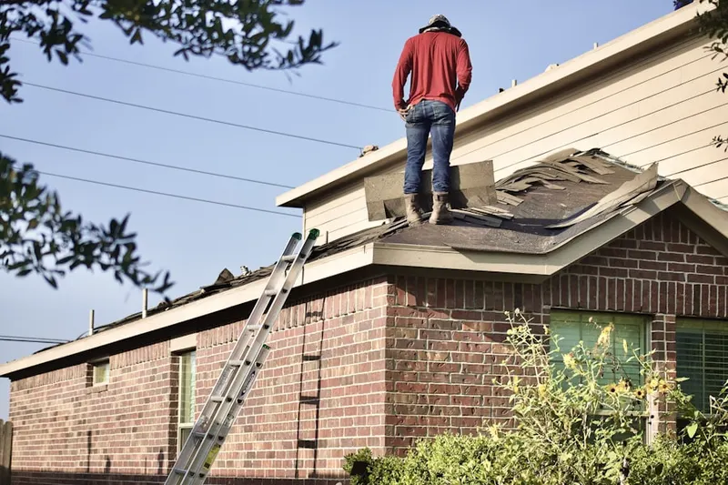 Professional roofer working on a residential roof in Highpoint